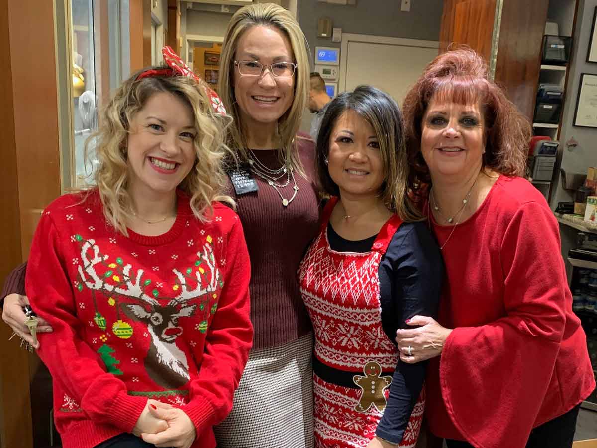 Four happy ladies dressed up for the holidays in the steven singer store.