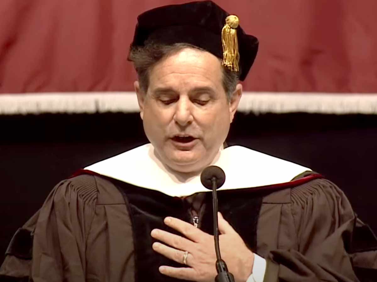 Steve Singer with a cap and gown on speaking at the Philadelphia University's 132nd commencement.