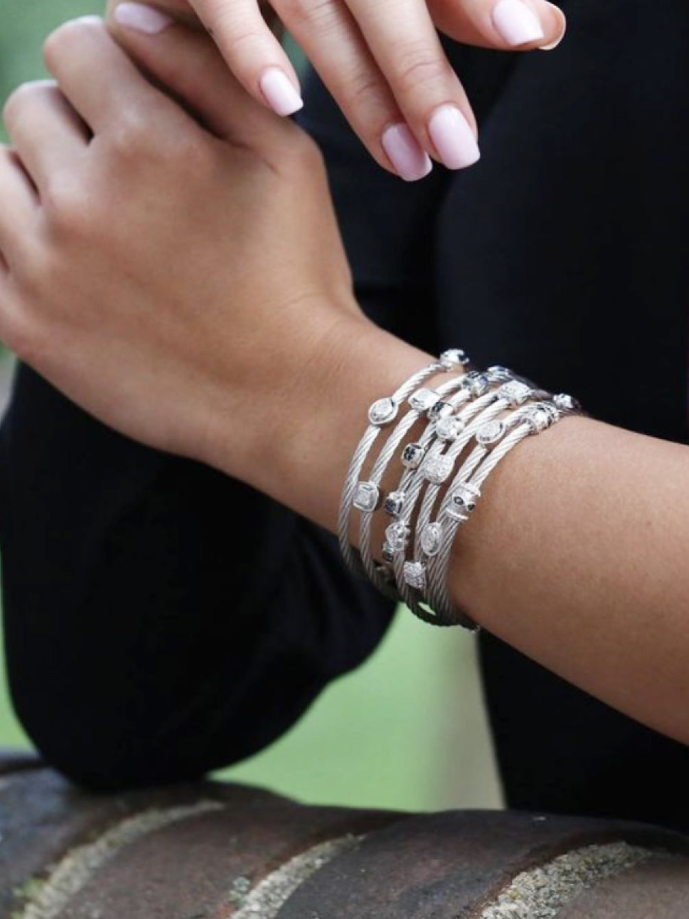 A lady with multiple of our bracelets on her left arm