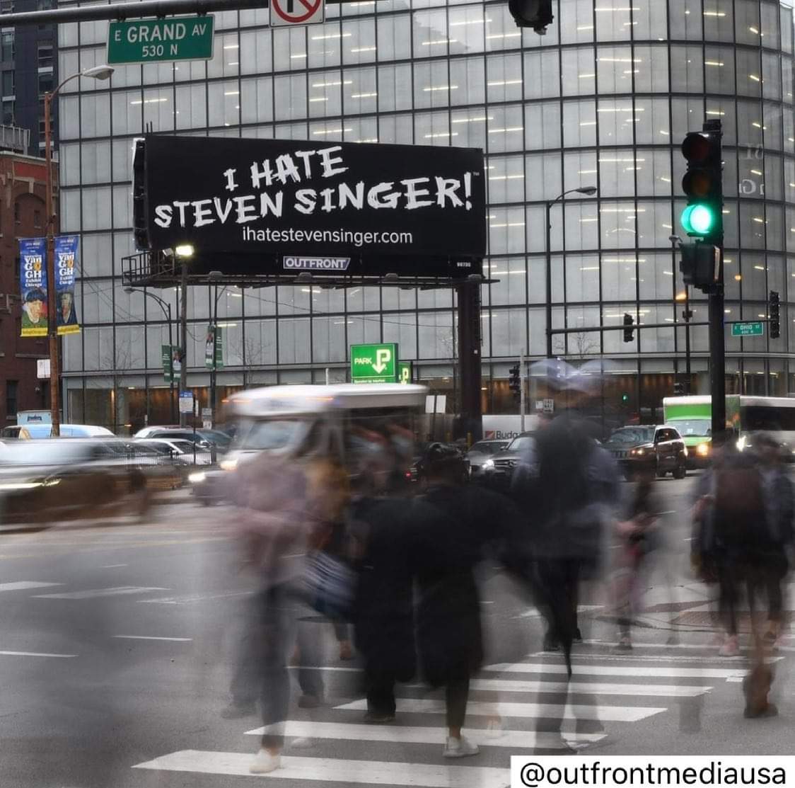 A "I Hate Steven Singer" billboard in the city.
