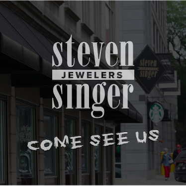 Front of steve singer store for the backdrop with the Steven Singer logo and the words "come see us" under.