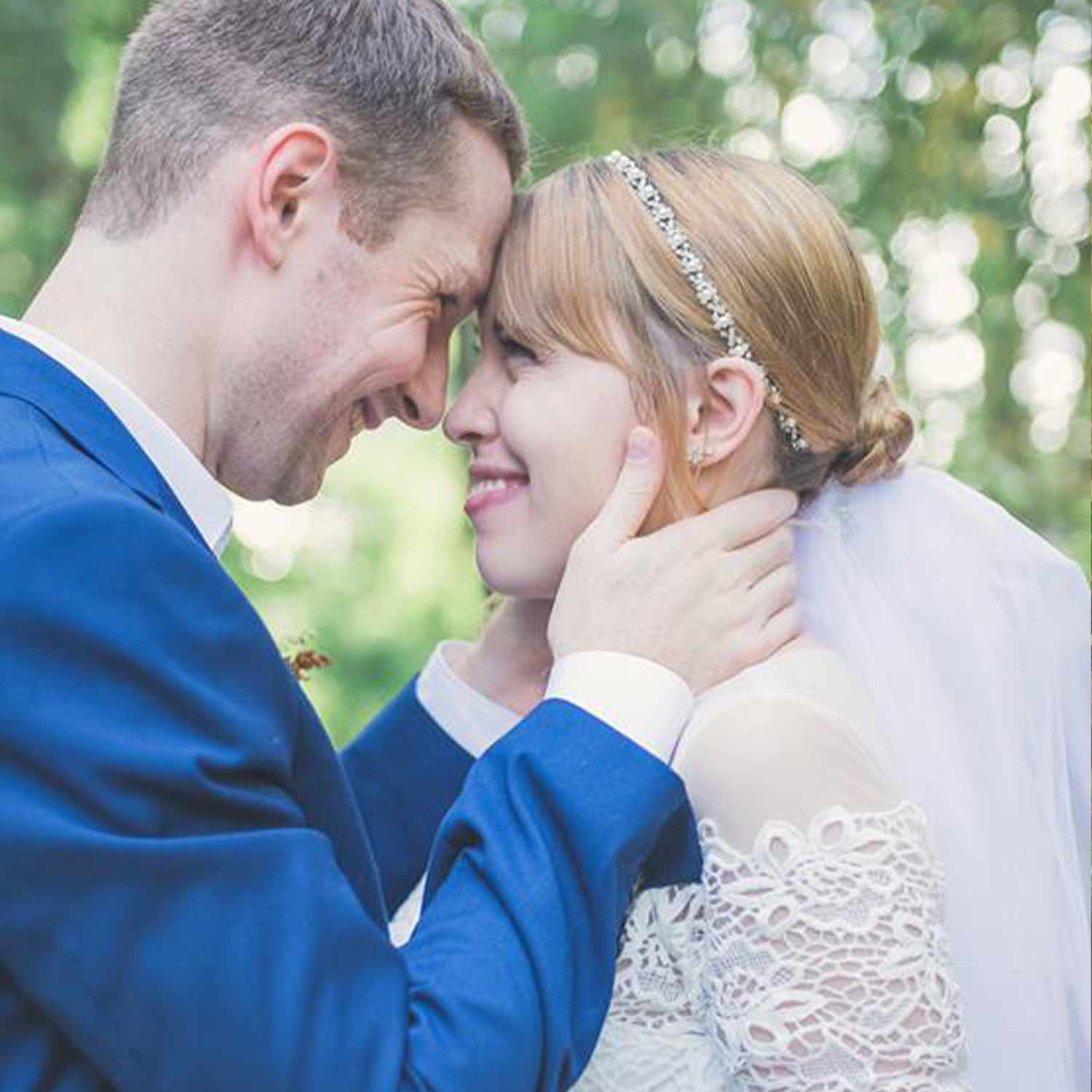 A man and woman touching foreheads with happy looks on both faces.