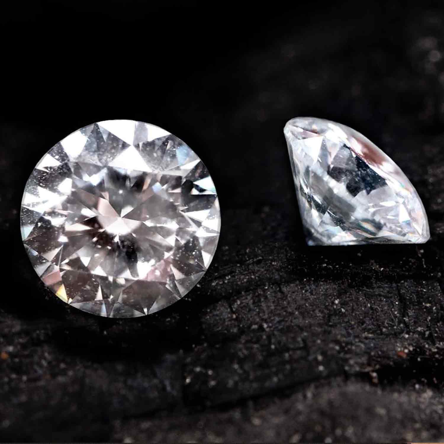 Two natural diamonds in front of a black background 