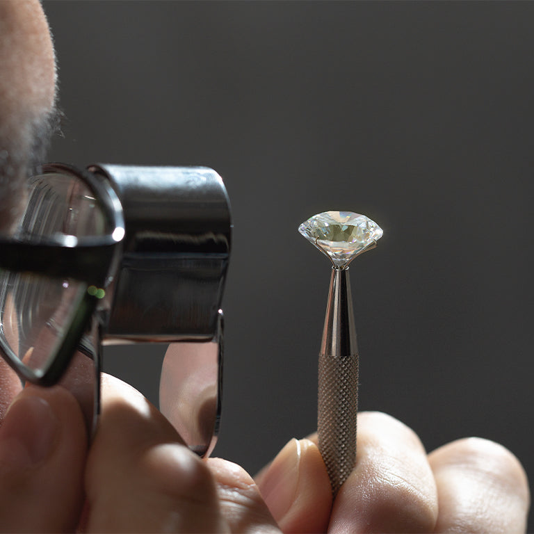 A man inspecting a diamond.