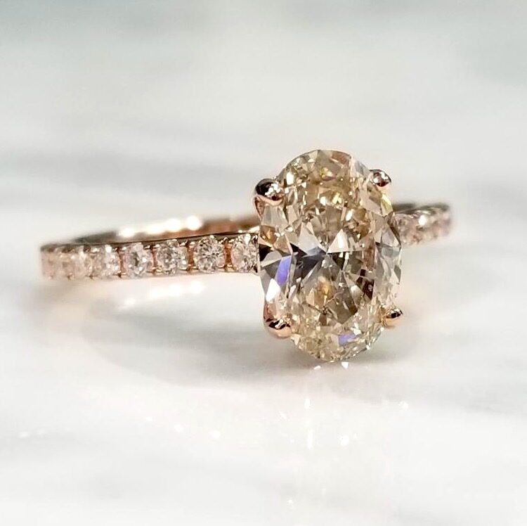 A flashy diamond ring with rose gold as the metal.