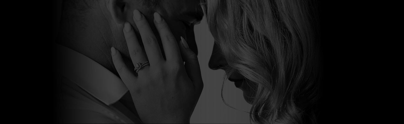 A woman holding both hands on a mans face.