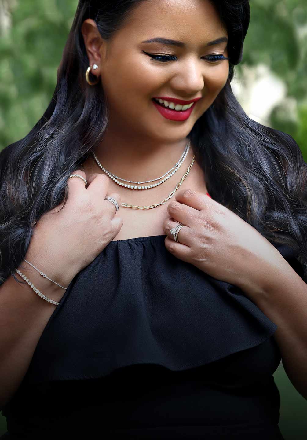 Picture of a beautiful woman wearing a layered selection of necklaces. Links to treat yourself gift ideas