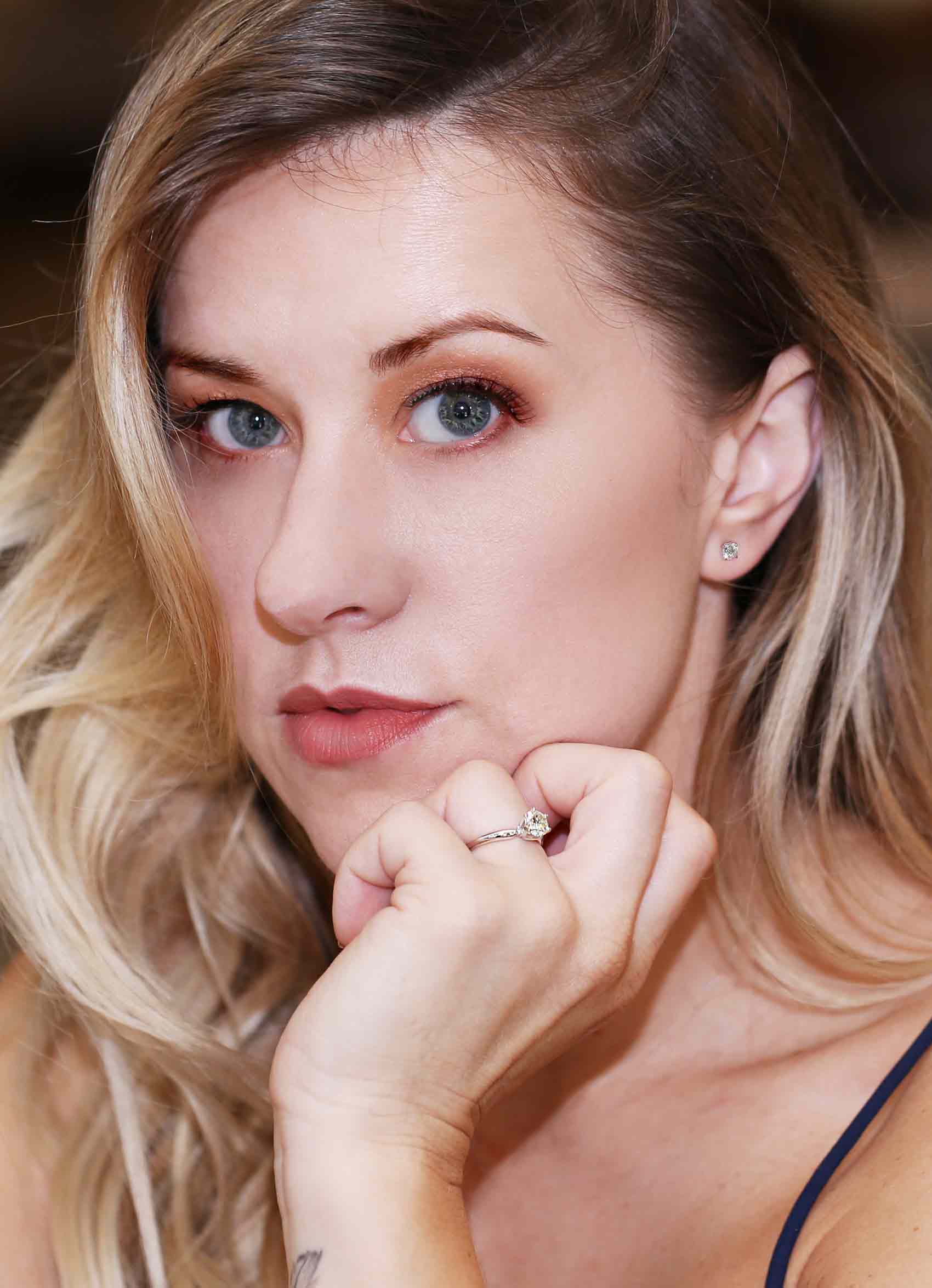 Picture of a woman featuring an engagement ring.