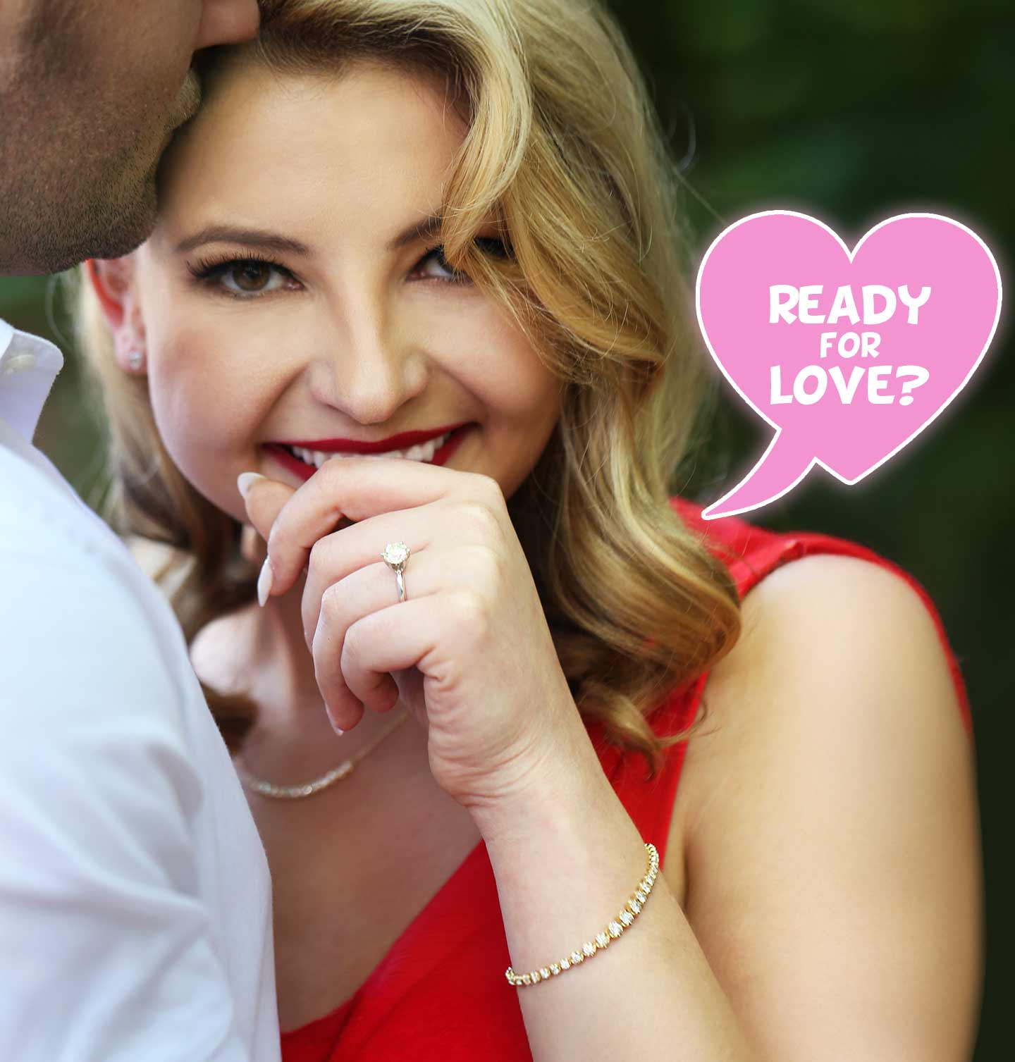 A woman smiling with a real, natural solitaire diamond engagement ring from Steven Singer Jewelers.
