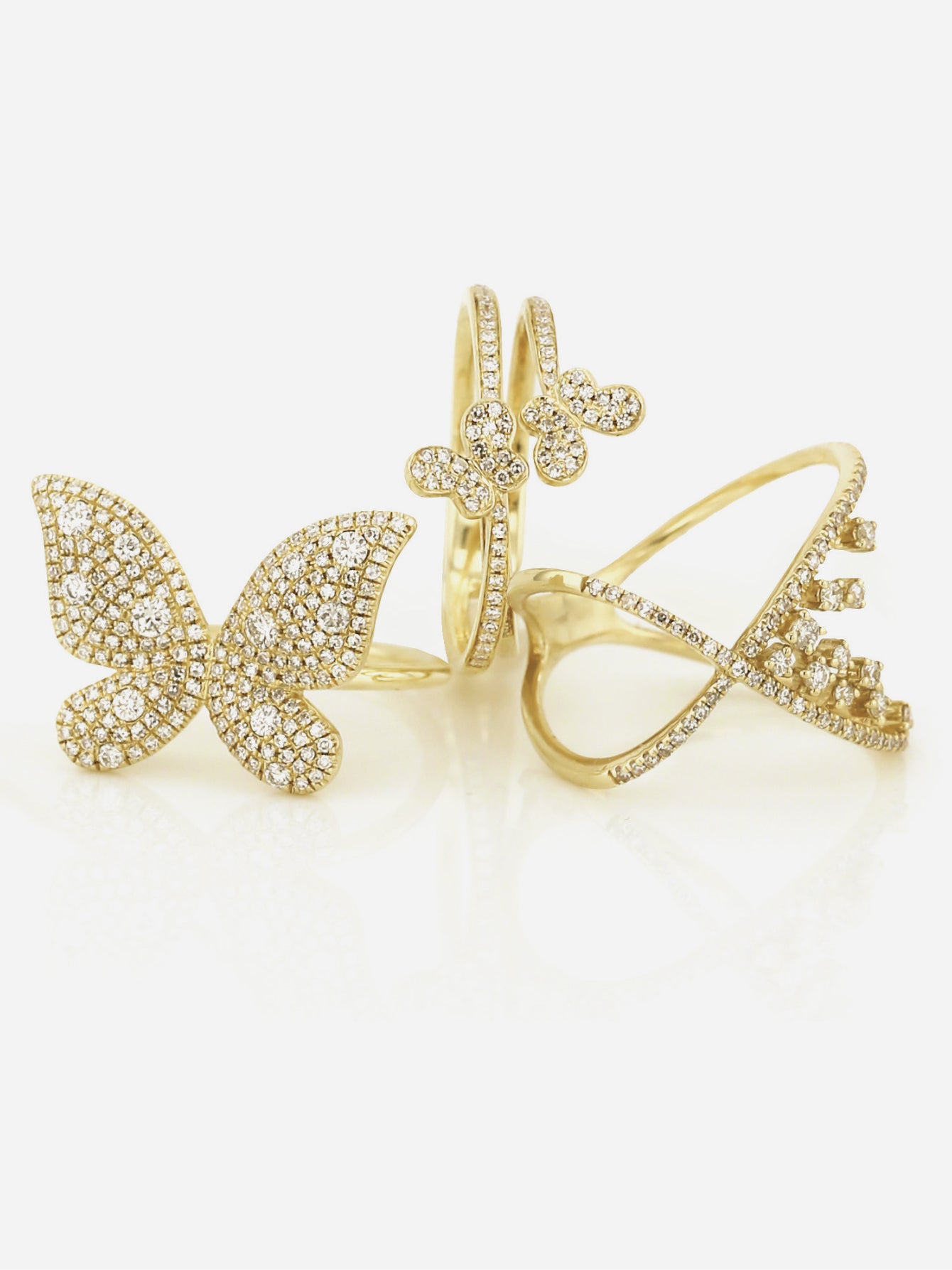 Three of our fashion rings, two with designs featuring butterflys.