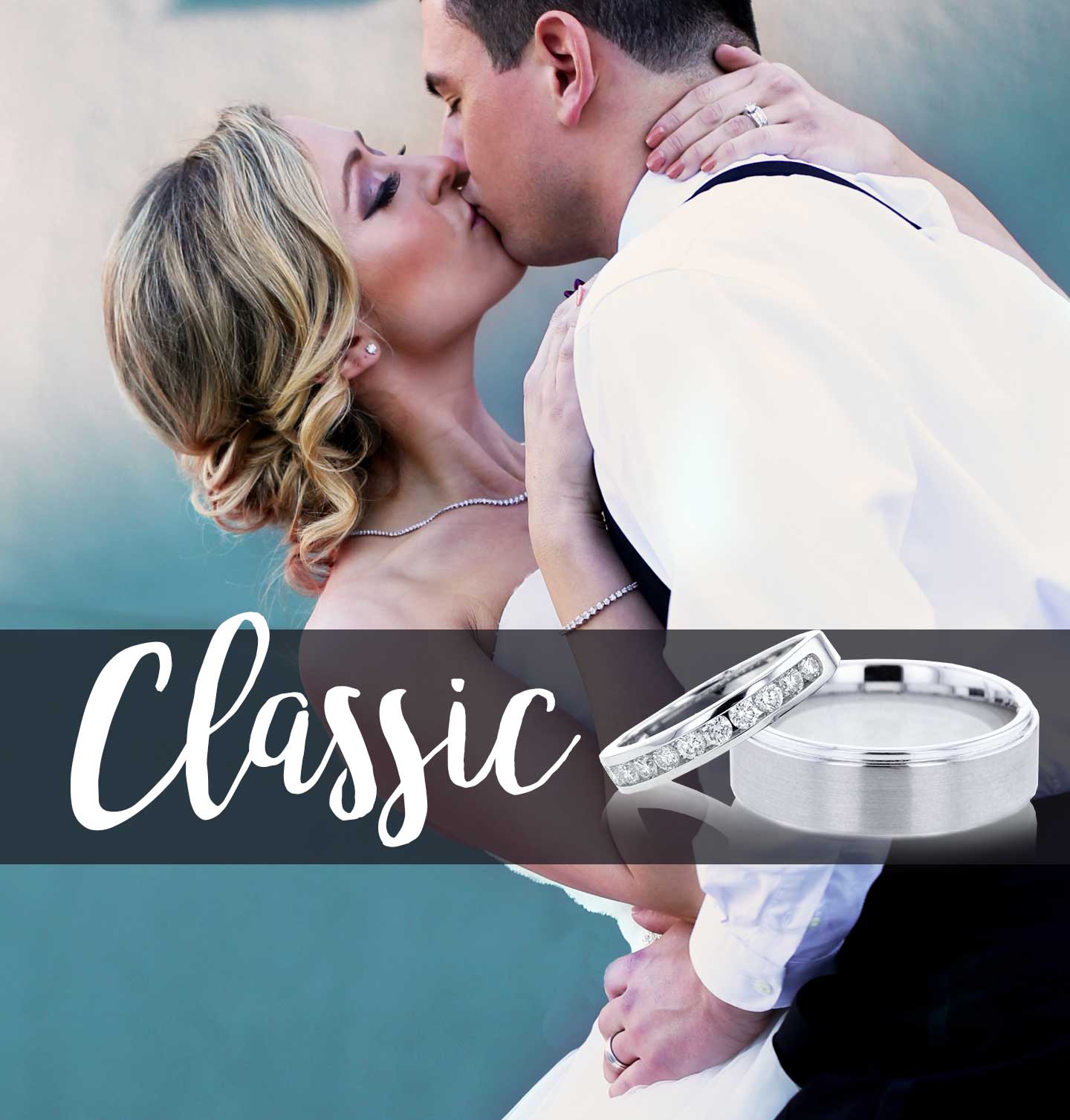 A classic bride and groom kissing on their wedding day wearing classic jewelry from Steven Singer.