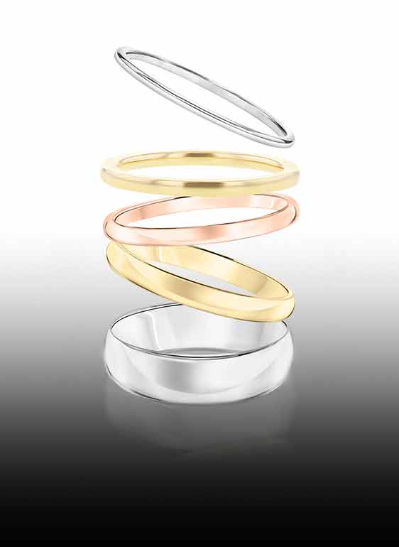 5 neutral gender wedding rings 2 being white gold, 2 yellow gold, and one rose gold.