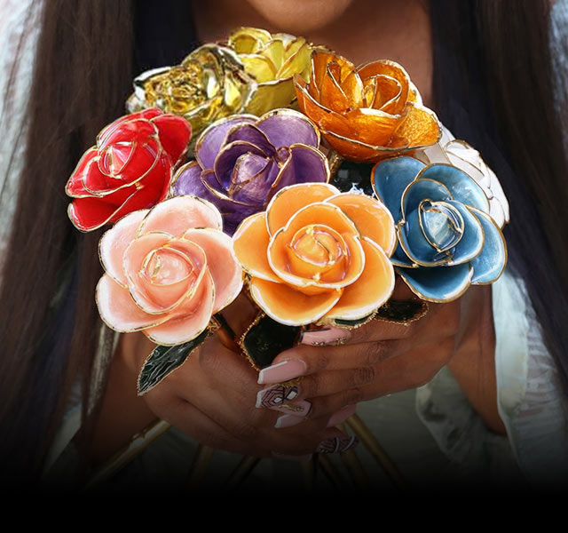 A woman holding a bouquet of our most famous gold dipped roses.