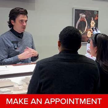 A couple shopping at a jewelry store with an expert jeweler from Steven Singer Jewelers.