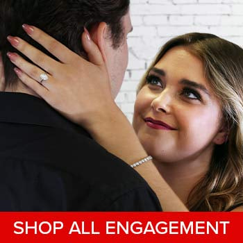 An engaged woman with her fiance wearing an engagement ring and tennis bracelet.